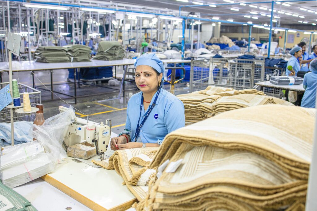 Indian factory worker in textile mill showcasing industrial production process.